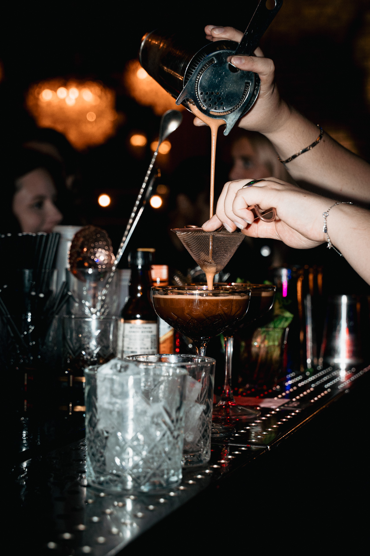 A pour finishing a cocktail.