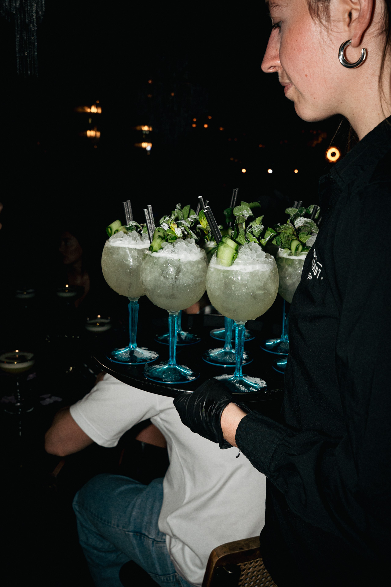A round of coupes lined up on the bar.
