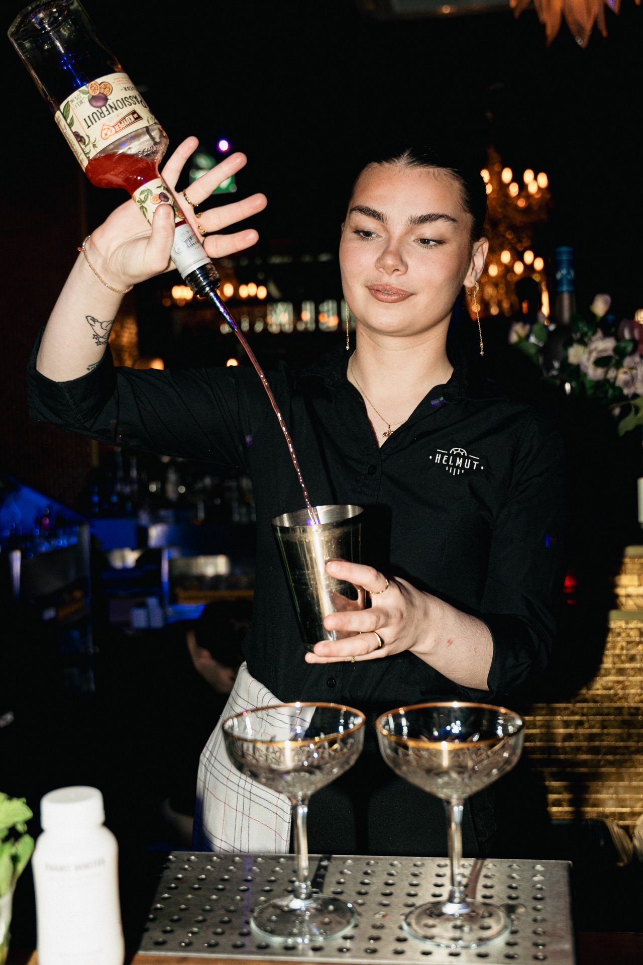 A bartender at the shaker mid-service.