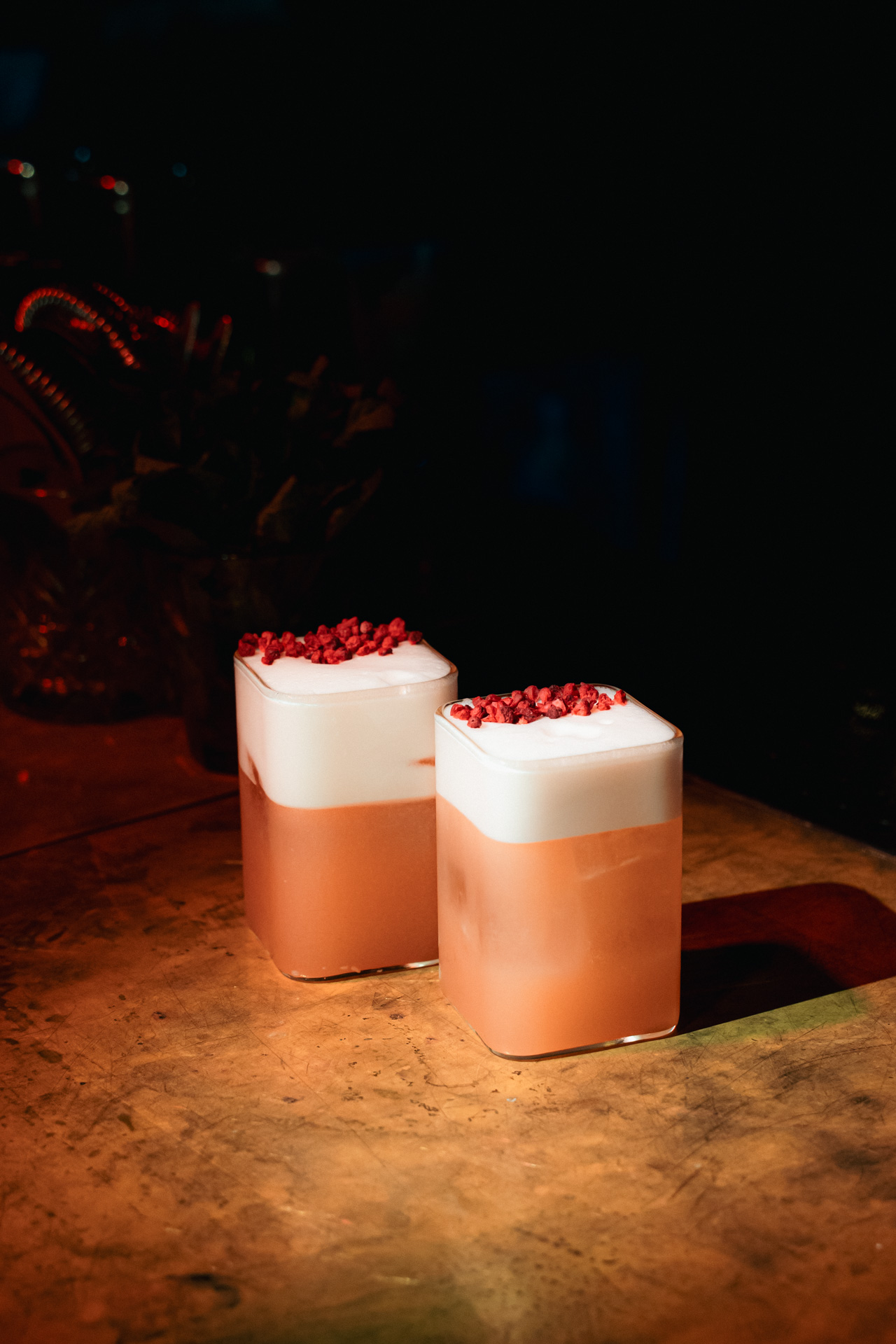 A pair of freshly poured sours on the bar.